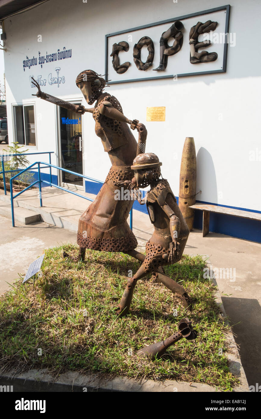 Statue made of unexploded ordnance (UXO) of a woman outside the COPE center which helps survivors of UXO.Vientiane,Laos,Asia. Stock Photo