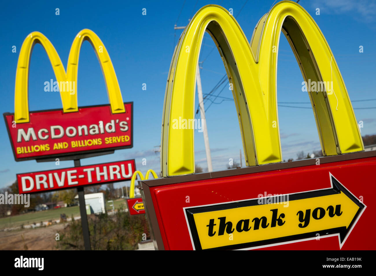 Multiple McDonald's 'Golden Arches' fast food restaurant signs. Stock Photo