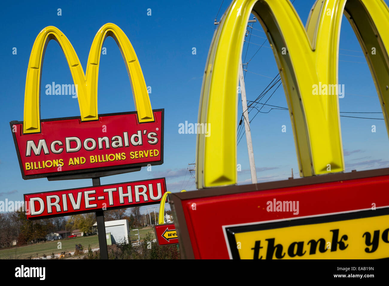 Multiple McDonald's 'Golden Arches' fast food restaurant signs. Stock Photo