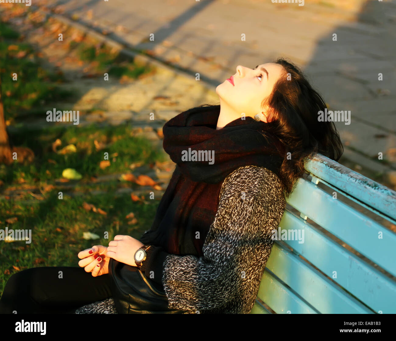 Girl sitting on the bench in the autumn in park Stock Photo - Alamy