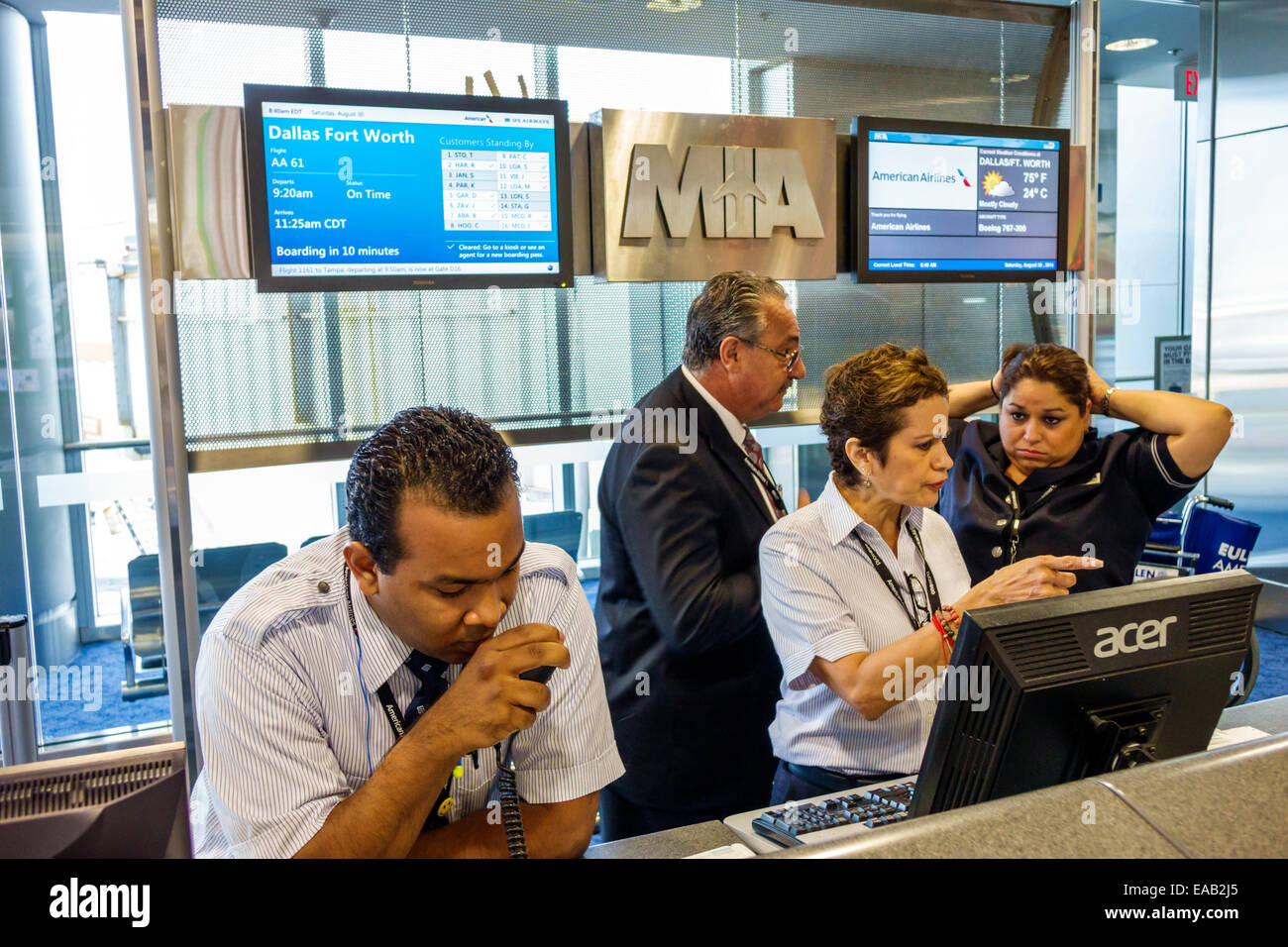 Miami Florida International Airport MIA,terminal,gate,American Airlines,agents,employee employees worker workers working staff,employees,Hispanic man Stock Photo
