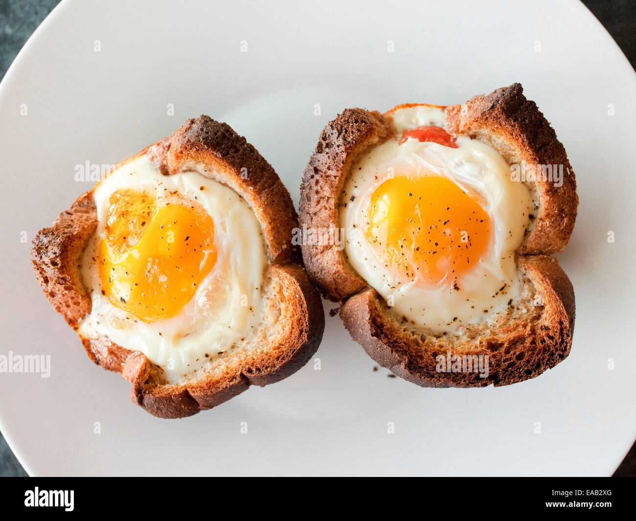 Two sunny side up eggs baked in toast Stock Photo