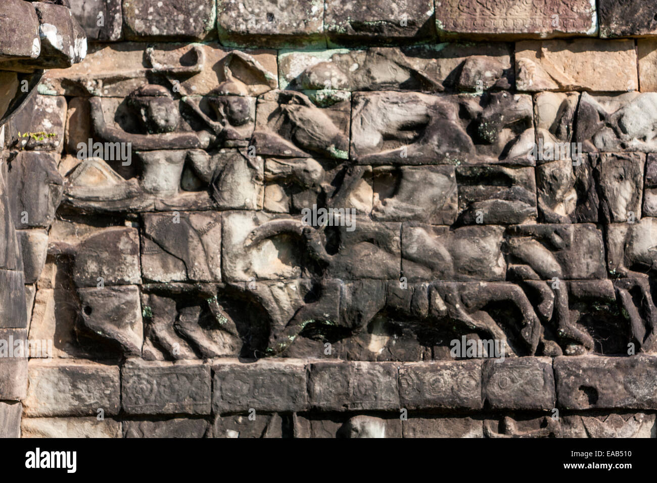 Cambodia, Angkor Thom.  Stone Carving Showing Soldiers and Horses in Battle. Stock Photo