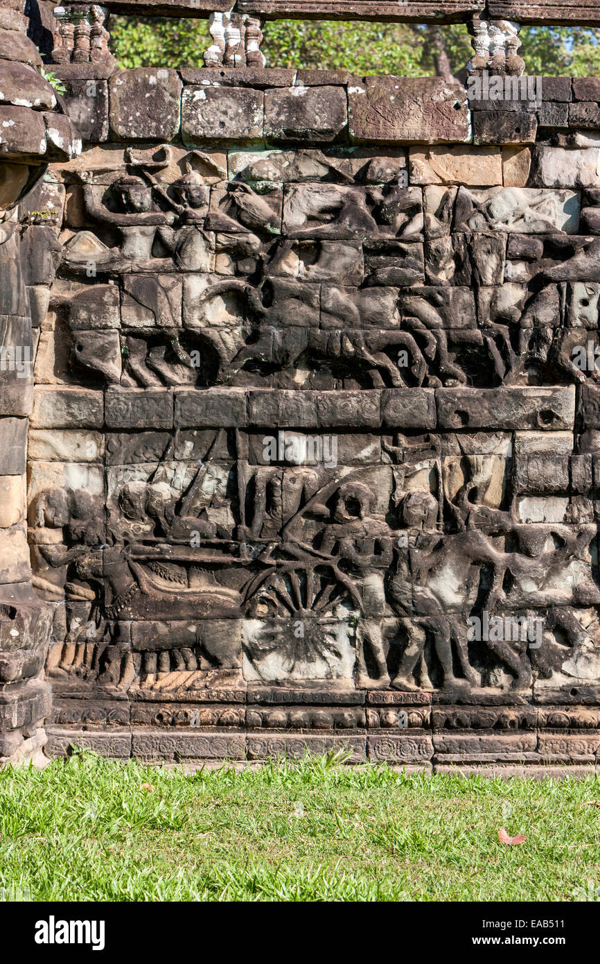 Cambodia, Angkor Thom.  Stone Carvings Depicting Soldiers in Battle,  with Horses and Cart. Stock Photo