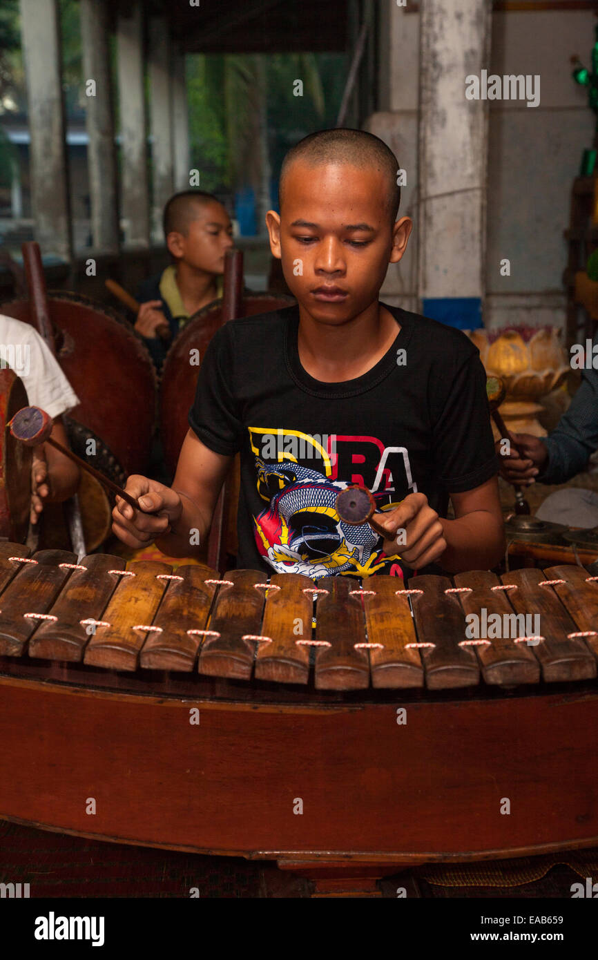 Cambodia, Angkor Wat. Young Boy Playing Xylophone (Roneat Stock Photo