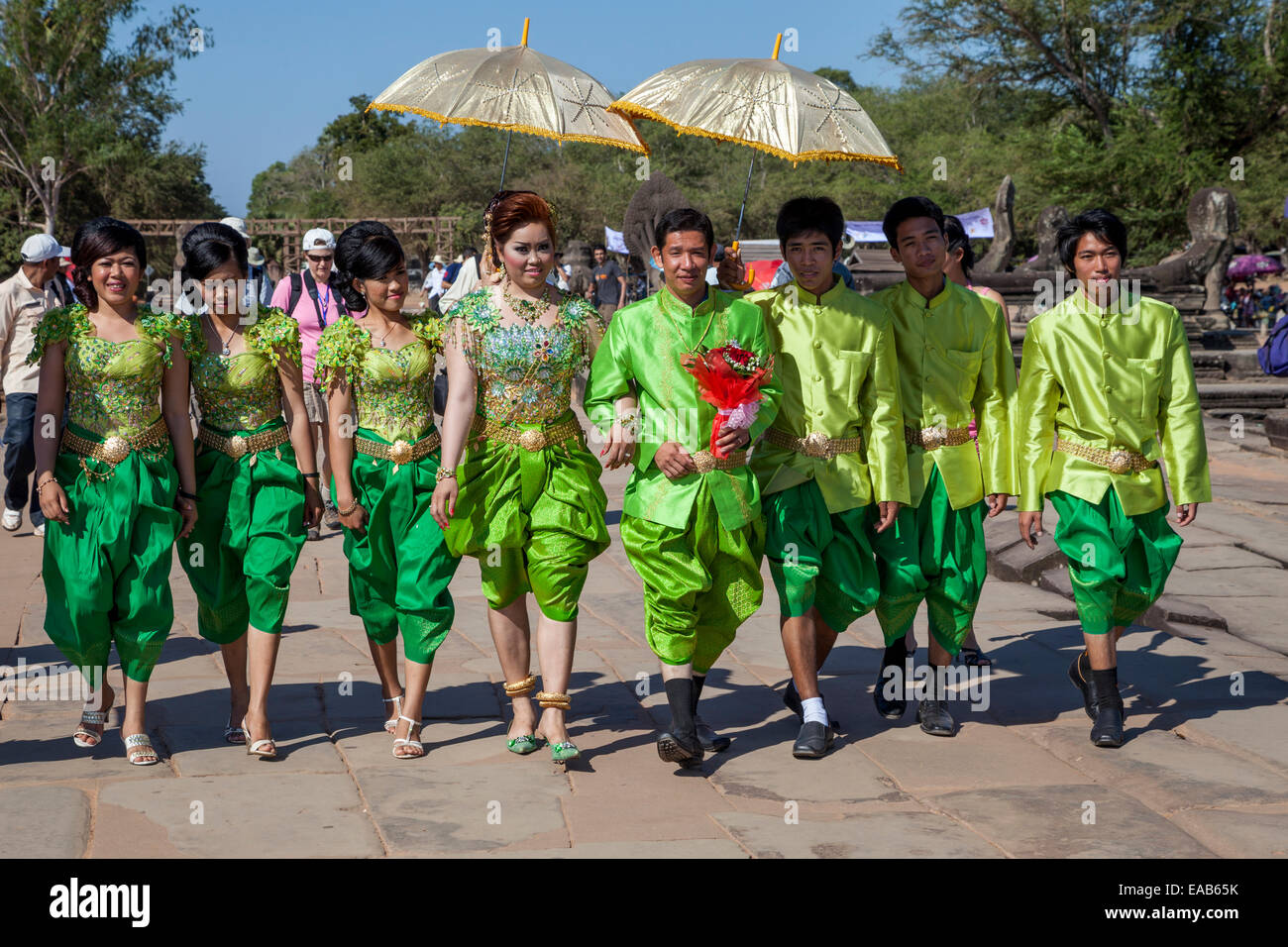 Cambodia, Angkor Wat.  Wedding Party Walking toward the Temple. Stock Photo