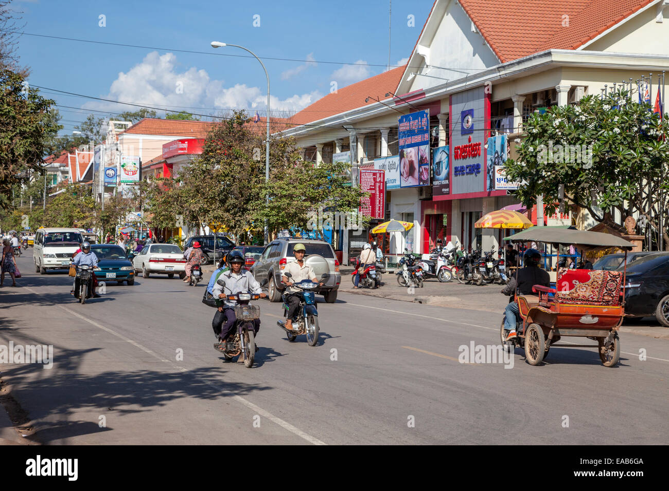 Cambodia, Siem Reap Street Scene with Bicycle-Taxi. Stock Photo