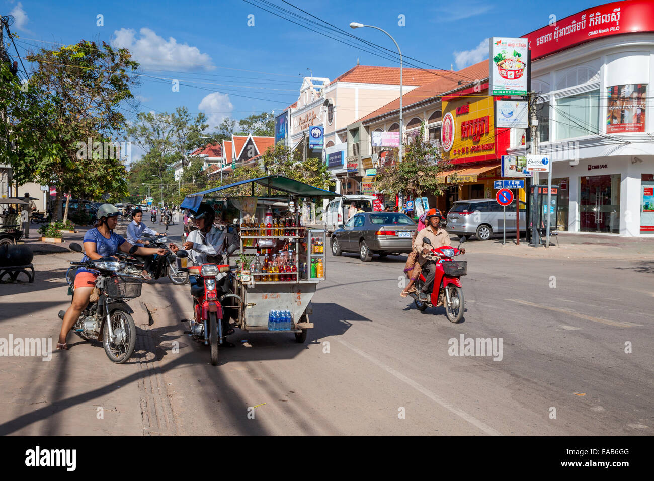 Cambodia, Siem Reap Street Scene with Soft Drink vendor and Customer. Stock Photo