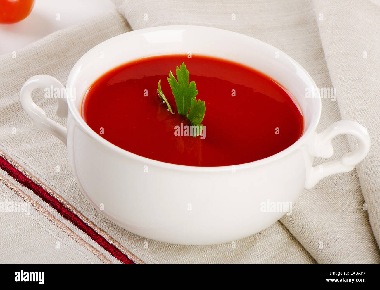Tomato soup in a white bowl . Selective focus Stock Photo