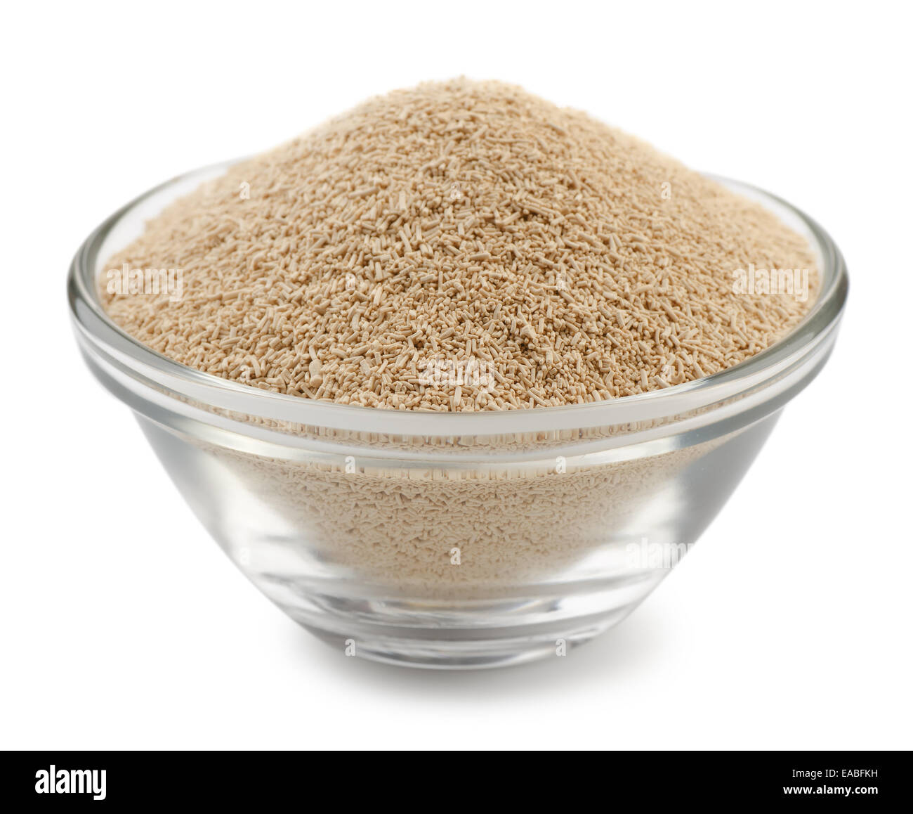 Dry yeast granules in glass bowl isolated on white Stock Photo