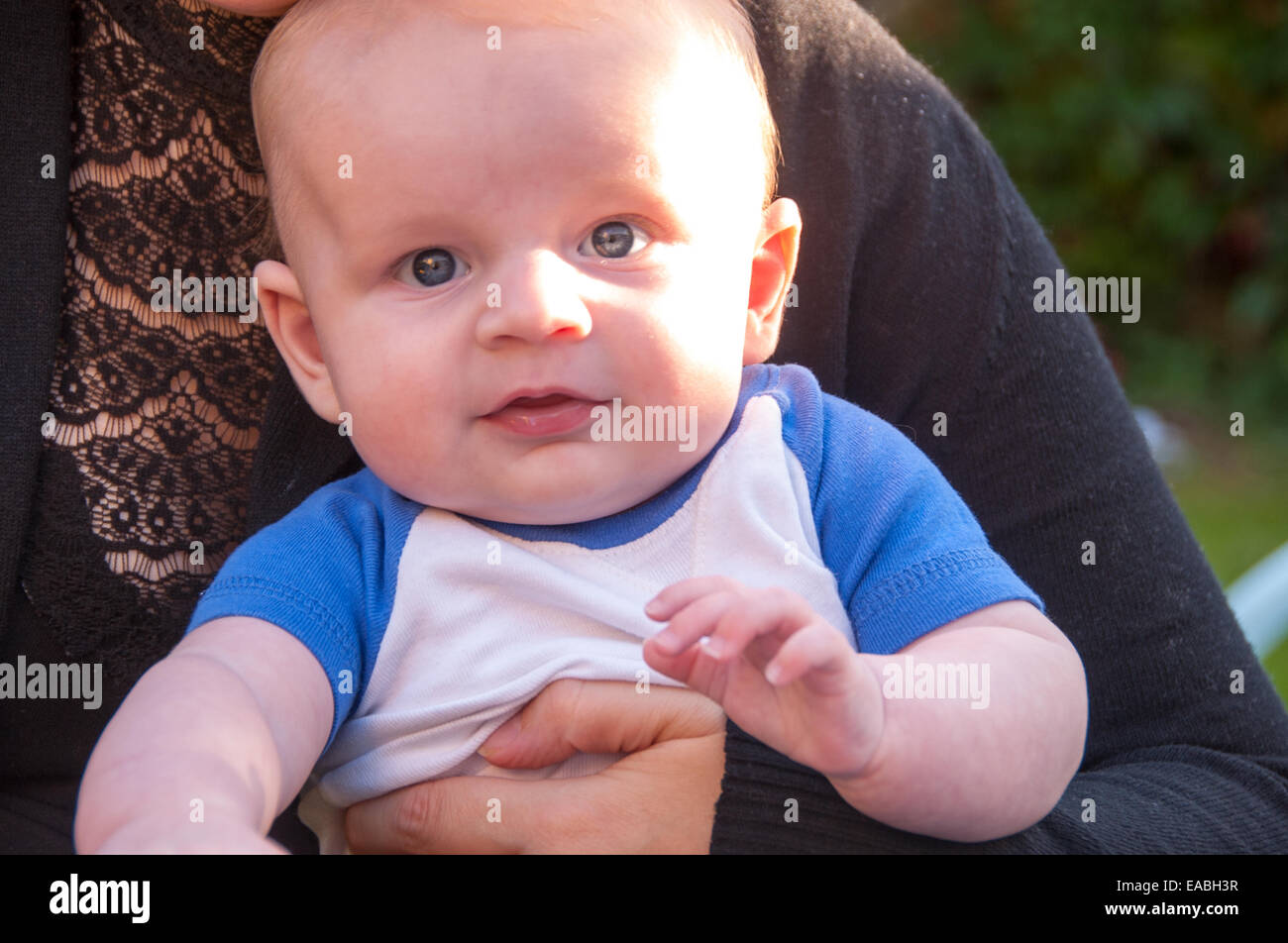 Mother holding son in her arms Stock Photo - Alamy