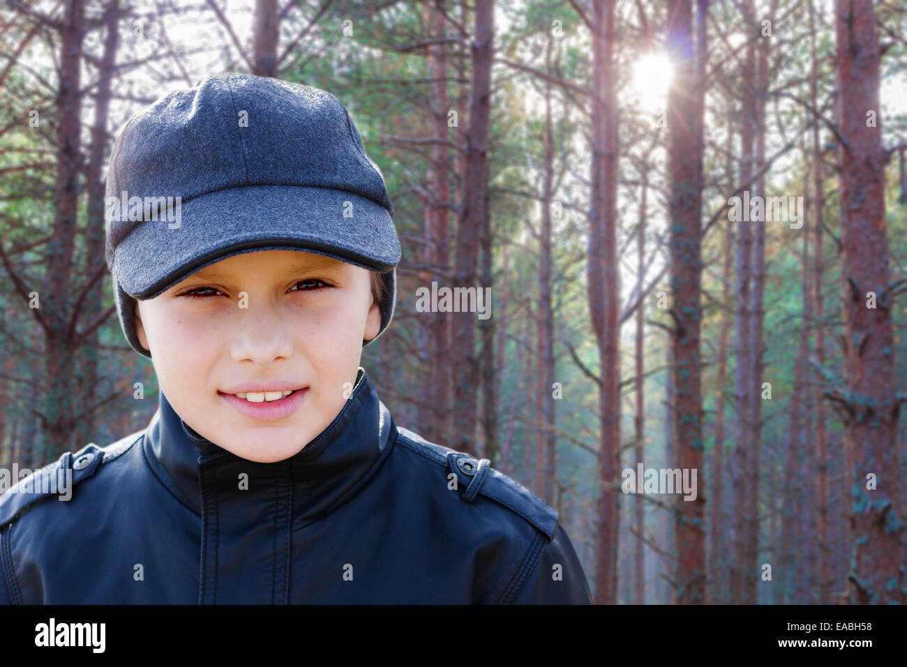 child boy back light portrait pine forest outdoor Stock Photo
