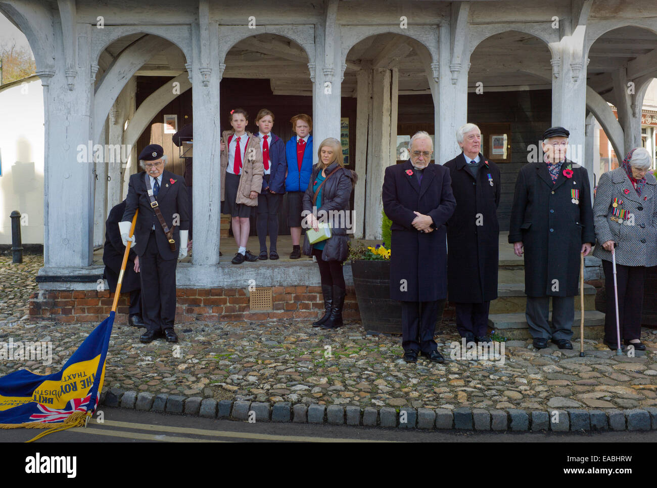 Thaxted, Essex, UK. Remembrance day 11 November 2014. The men, women and children of Thaxted a small town in north Essex remember the fallen from both WWI and WWII as well as those who have died in more recent conflicts seen here outside the 14th cent. Guildhall. Credit:  BRIAN HARRIS/Alamy Live News Stock Photo