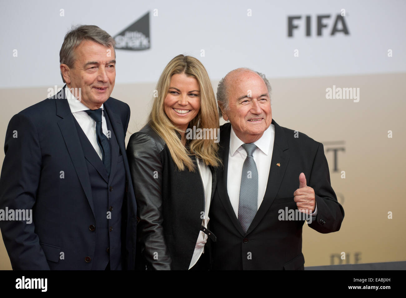Sony Center, Potsdamer Platz, Berlin, Germany. 10th Nov, 2014. President of the German Football Association Wolfgang Niersbach (L) and his girlfriend Marion Popp arrive with FIFA President Joseph Blatter (R) for the world premiere of the film 'Die Mannschaft' (lit. 'The team') at the Cinestar movie theater at Sony Center, Potsdamer Platz, Berlin, Germany, 10 November 2014. The film is the official documentary of the FIFA Soccer World Championship 2014 in Brazil. PHOTO: Joerg Carstensen/dpa/Alamy Live News Stock Photo