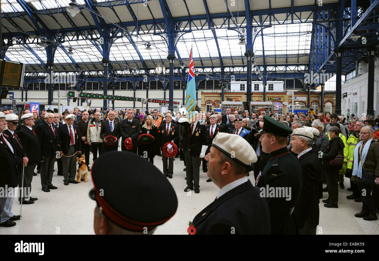 Brighton, UK. 11th November, 2014. Members of the RAF Police Association and Blind Veterans UK lead a Guard of Honour Parade and two minutes silence at Brighton Railway Station at 11am for Armistice Day Remembrance . Stock Photo