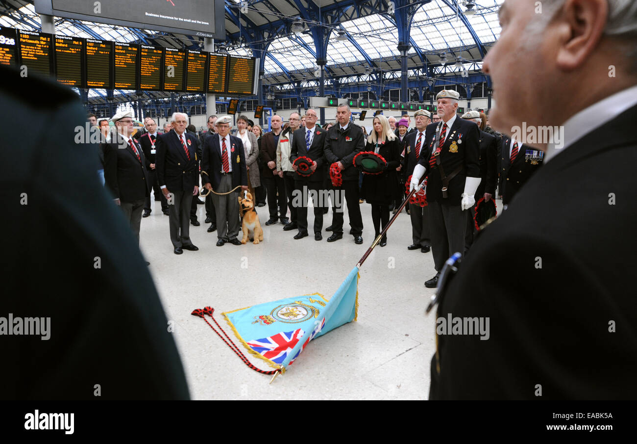 Brighton, UK. 11th November, 2014. Members of the RAF Police Association and Blind Veterans UK lead a Guard of Honour Parade and two minutes silence at Brighton Railway Station at 11am for Armistice Day Remembrance . Stock Photo