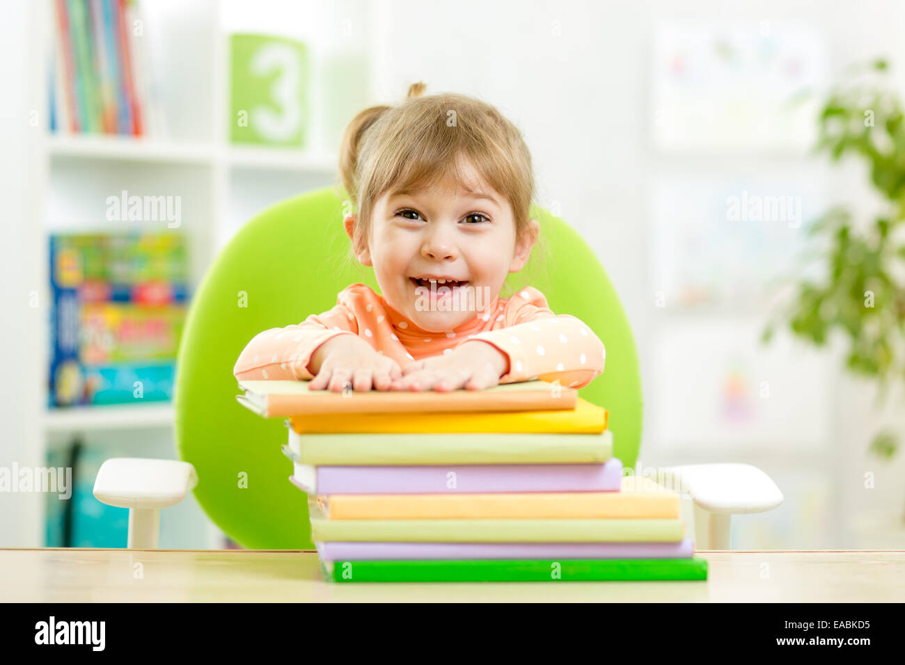 Cute kid girl preschooler with books Stock Photo - Alamy