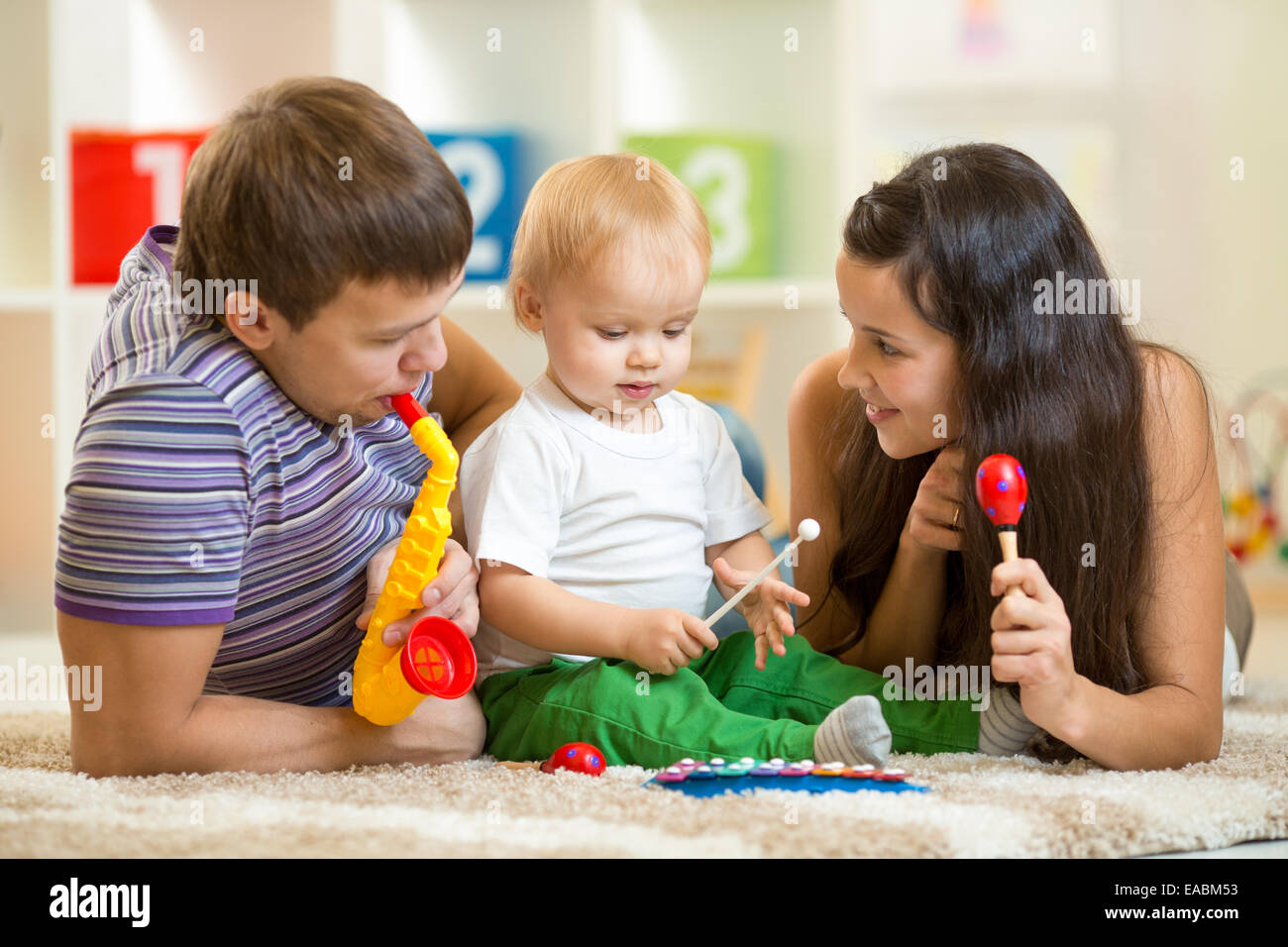 Happy family play musical toys Stock Photo - Alamy