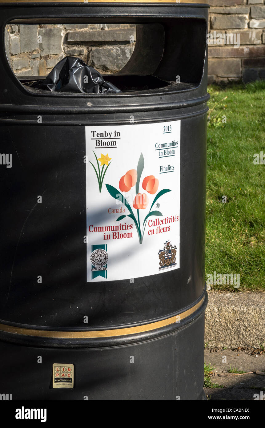 Communities in Bloom poster attached to a public refuse bin in Tenby UK Stock Photo