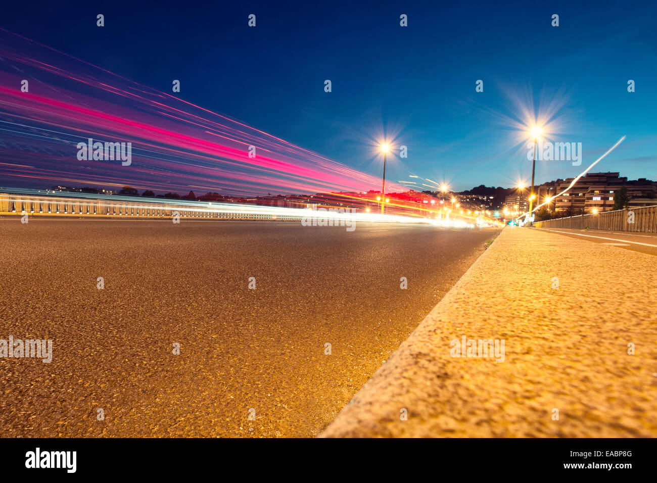 Moving cars with blur light through city at night. Stock Photo