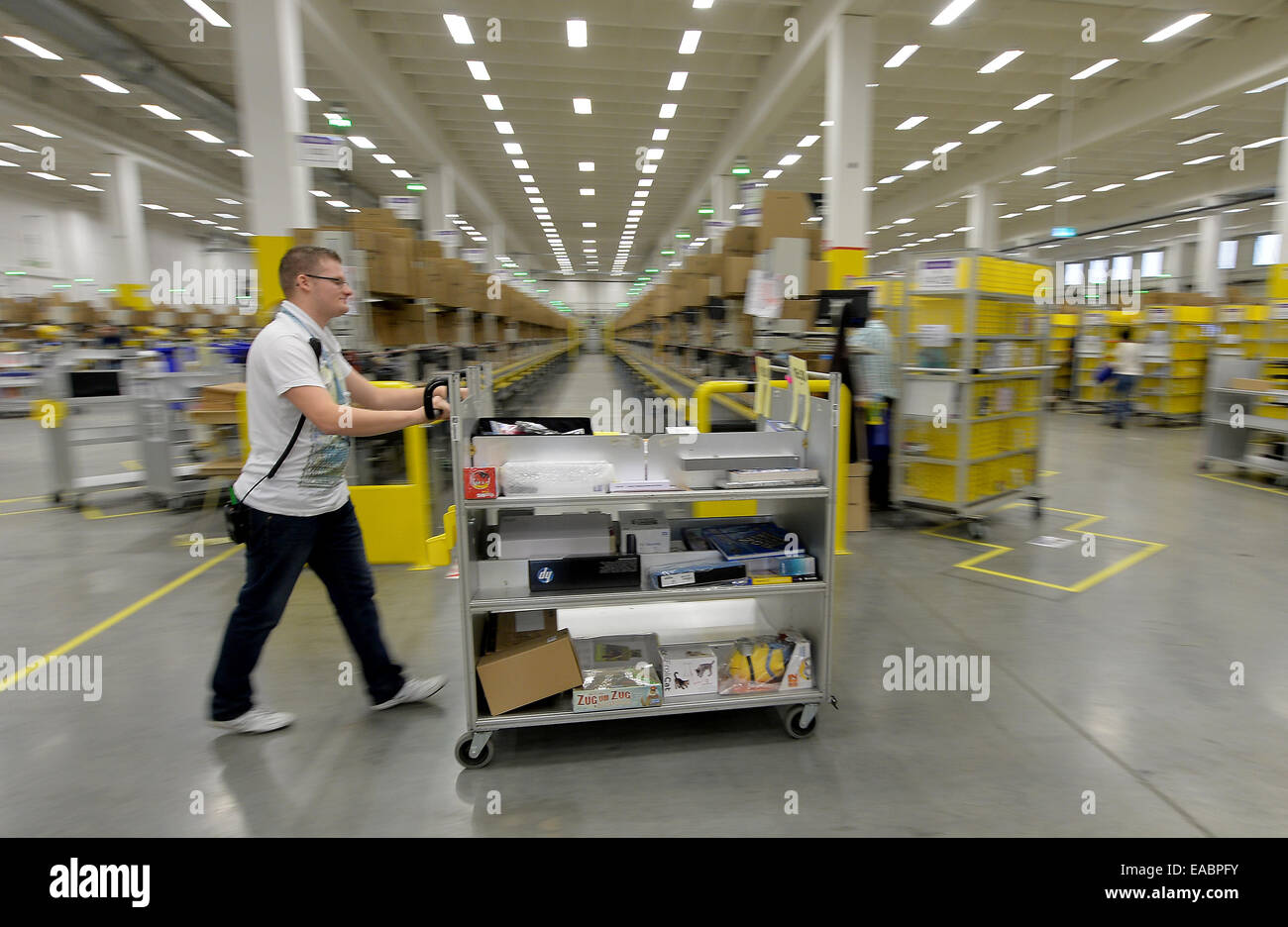 Orders are prepared for delivery at the Amazon logistics center in ...
