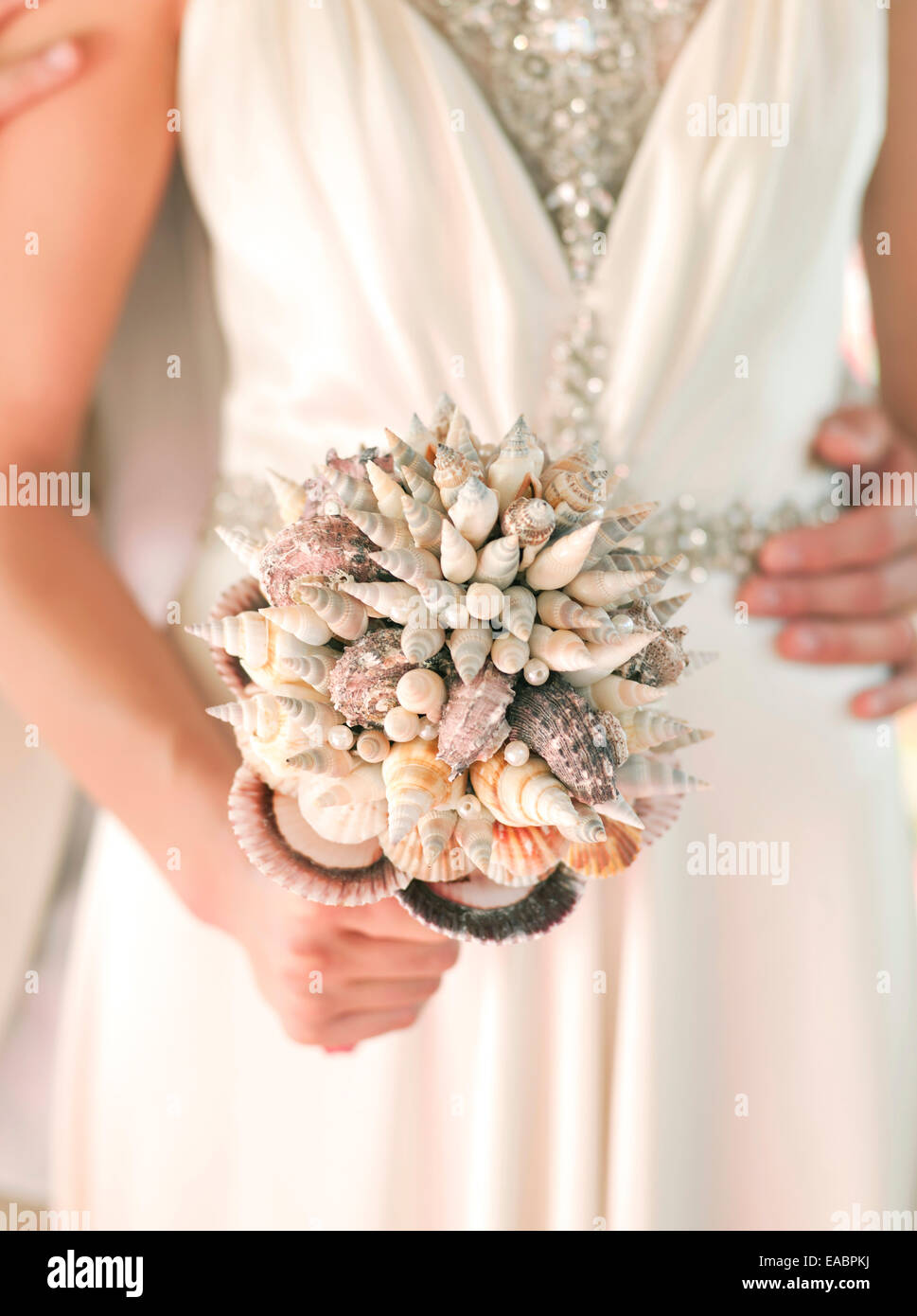 bride holding a wedding bouquet made of sea shells bride Stock Photo