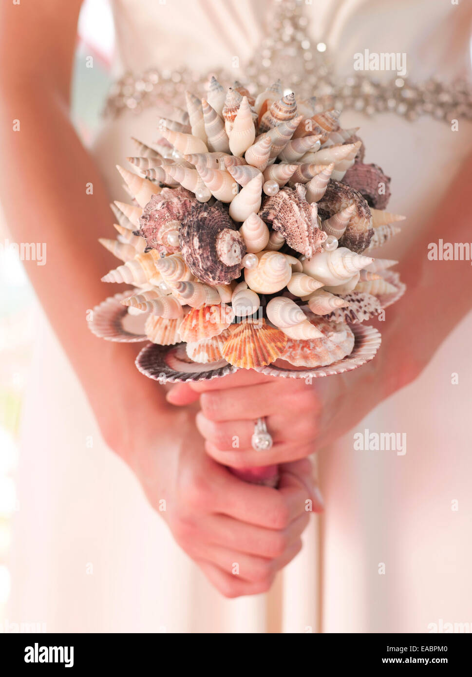 holding a wedding bouquet made of sea shells Stock Photo