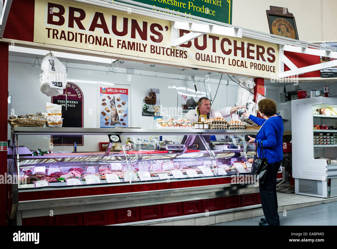 Butcher serving a customer in Tenby's Indoor Market Stock Photo Alamy