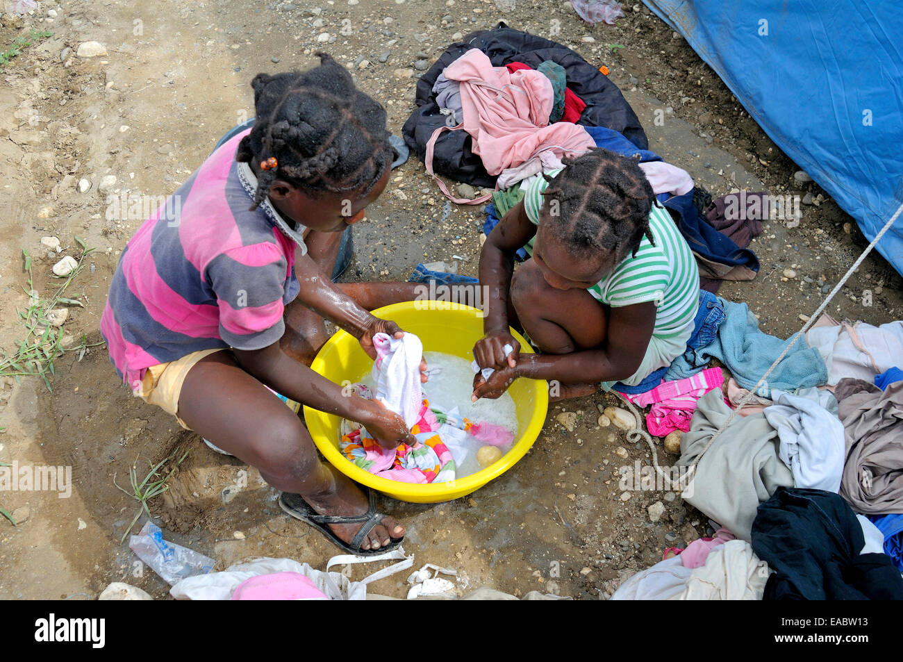 Haiti Port-au-Prince Croix-des-Bouquets Little girls washing laundry Stock Photo