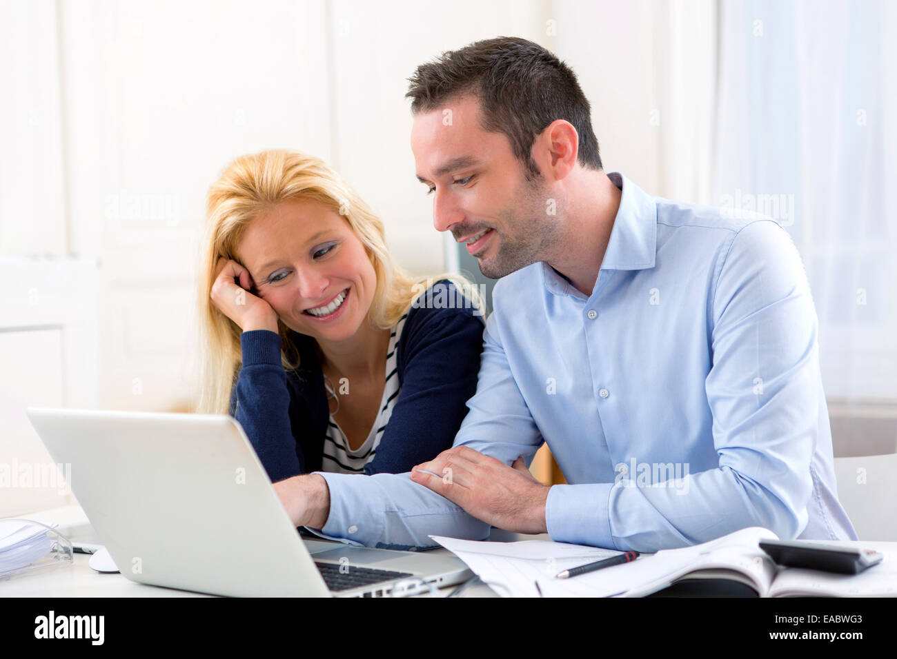 View of a Young attractive couple using laptop at home Stock Photo - Alamy