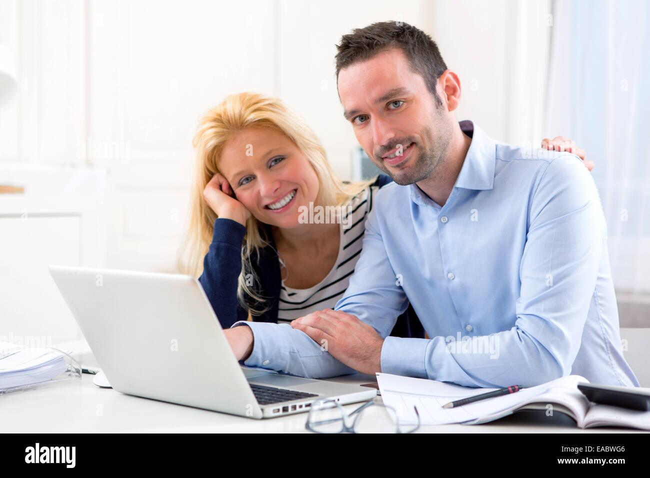 View of a Young attractive couple using laptop at home Stock Photo - Alamy