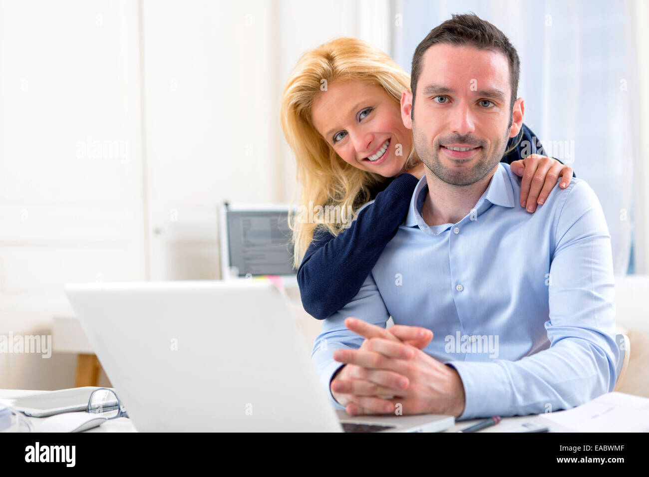 View of a Young attractive couple using laptop Stock Photo - Alamy
