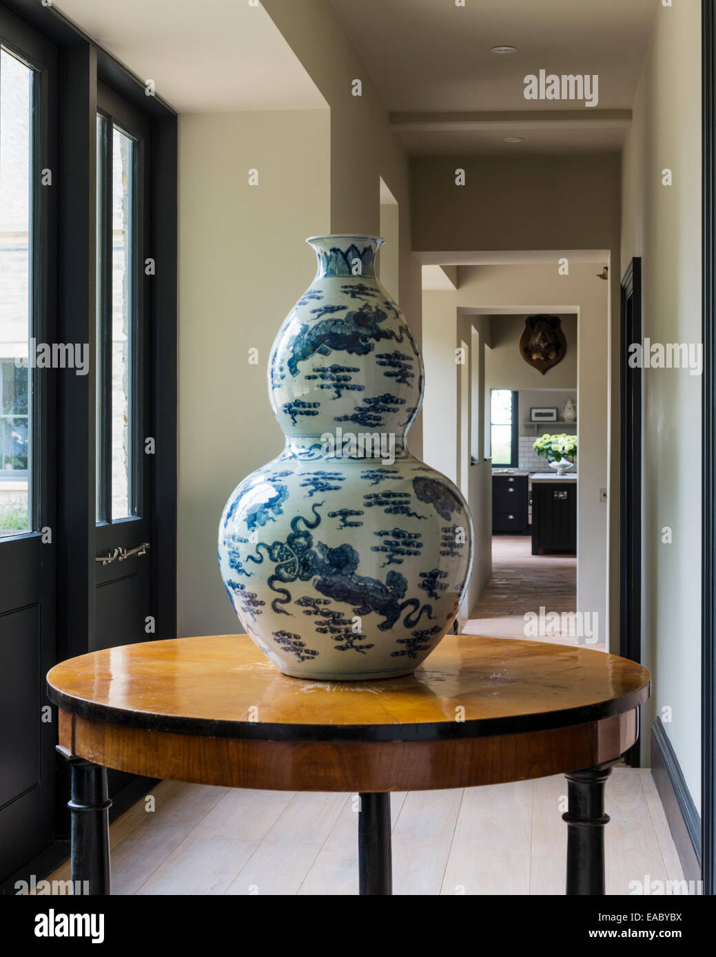 Double gourd chinese vase on antique round table in corridor Stock Photo