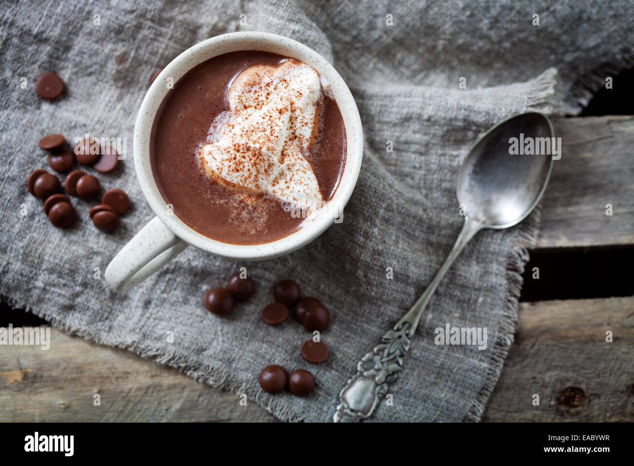 Glass cup of Hot chocolate with marshmallows in knitted cup holder with  cookies, chopping chocolate and mittens over wooden wind Stock Photo - Alamy