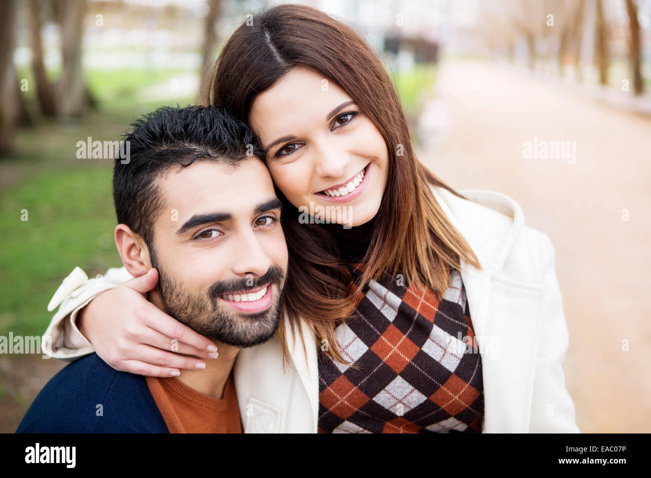 Young romantic couple on a bench in park Stock Photo - Alamy