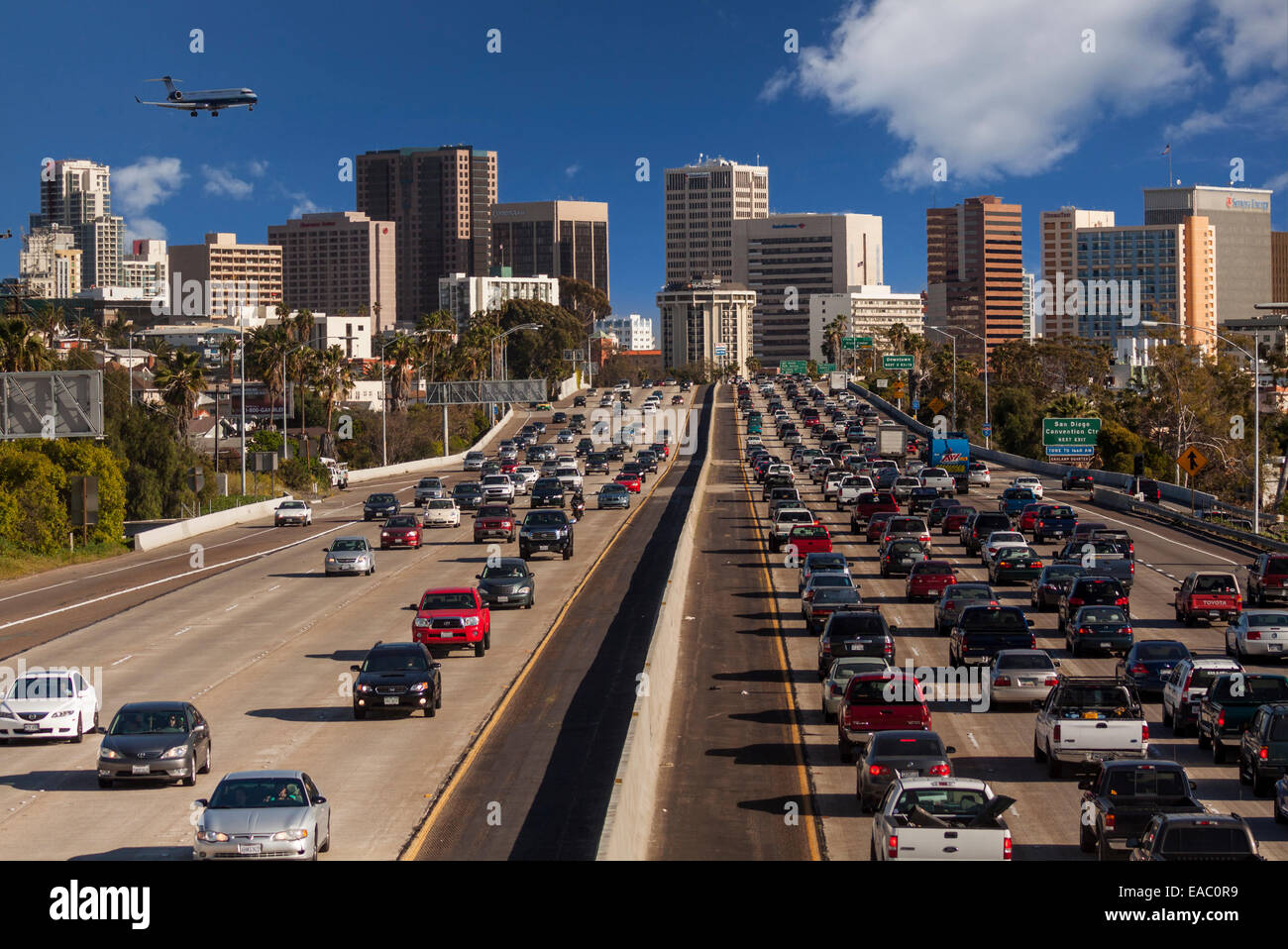 Traffic on Interstate highway 5 with jet airliner on final approach to airport-San Diego, California, USA. Stock Photo