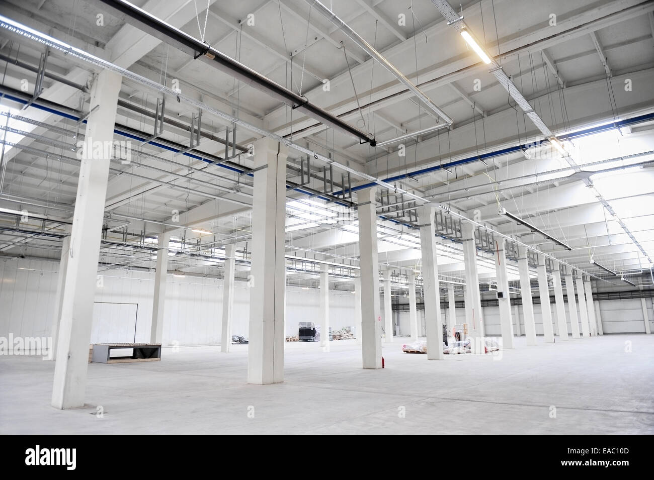 Interior detail with an empty industrial storage depot with ceiling heating system Stock Photo