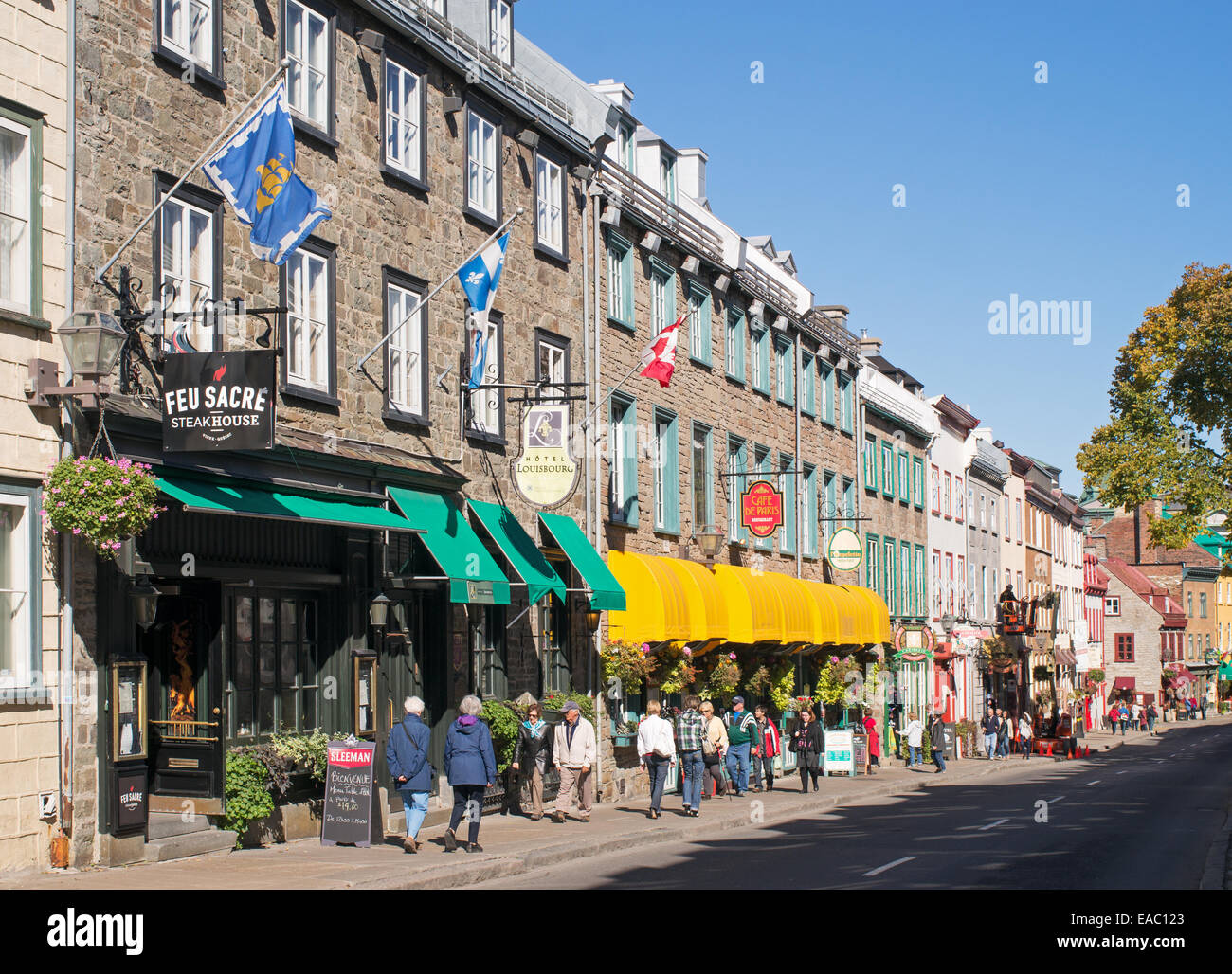 People walking along Rue Saint Louis past the Restaurant Le Feu Sacré, old Quebec, Canada Stock Photo