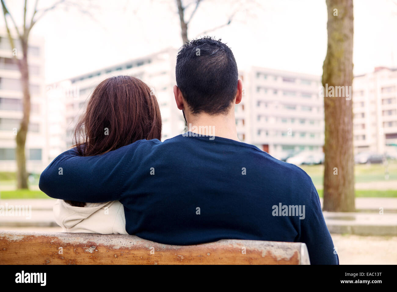 Young romantic couple on a bench in park Stock Photo - Alamy
