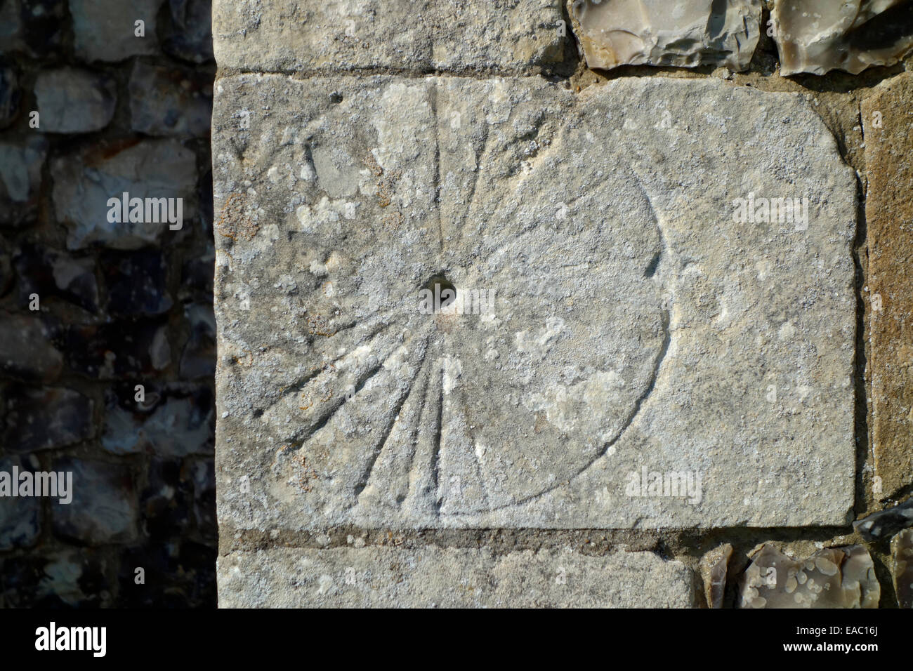 A mass dial scratched onto a cornerstone of St Catherine's Church, Ludham Stock Photo