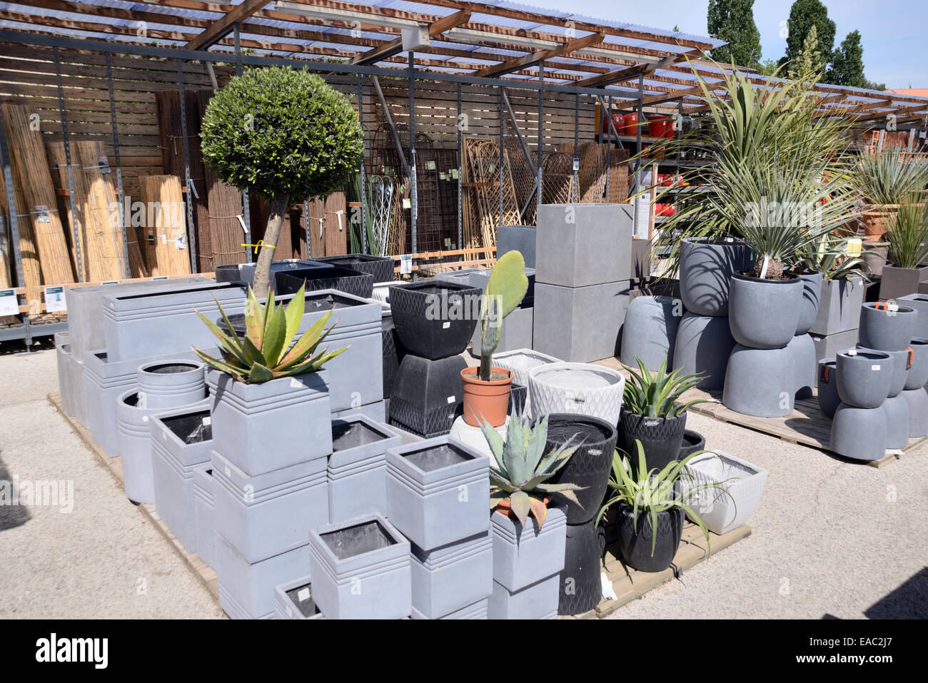 Display of Contemporary or Modern Style Gray or Grey Planters or Plant Pots for Sale in Garden Center or Garden Centre Stock Photo