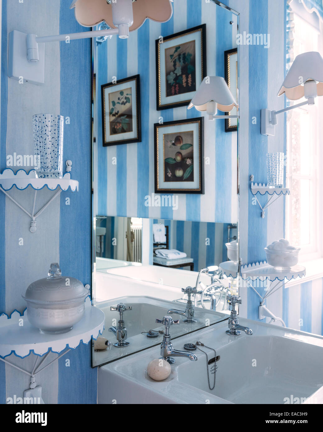 Blue and white bathroom detail with artwork reflected Stock Photo