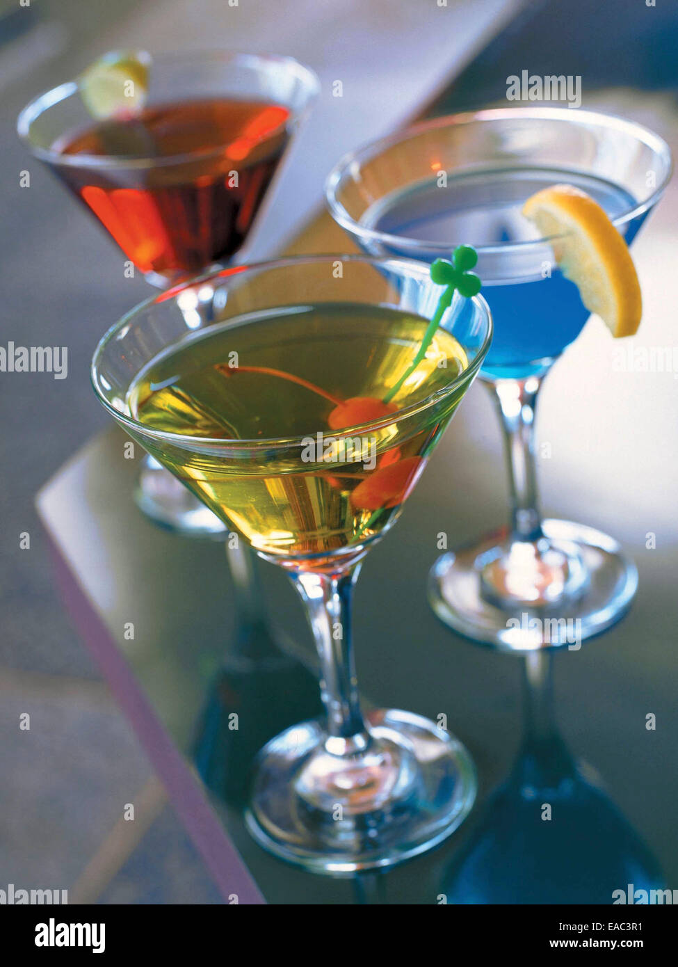 3 colorful martinis on bar counter Stock Photo
