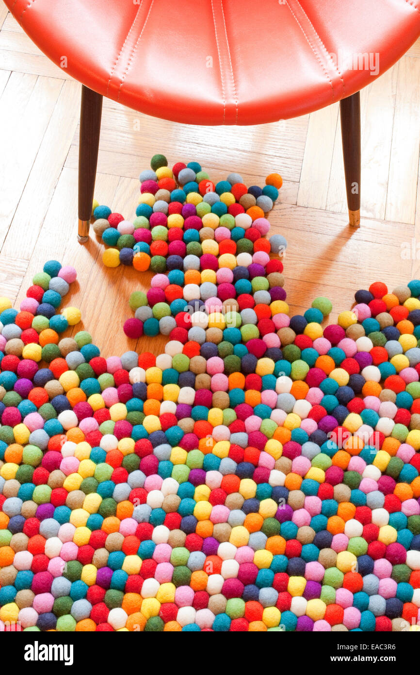 Colorful Rug and chair on wood floor Stock Photo