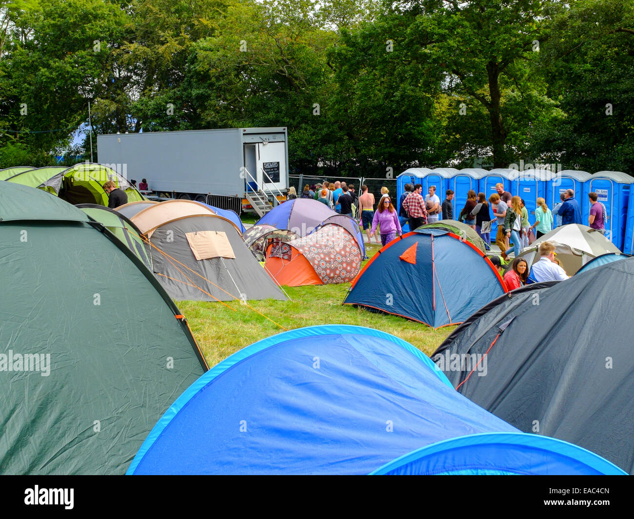 Campers queuing for  showers at festival campsite. Stock Photo