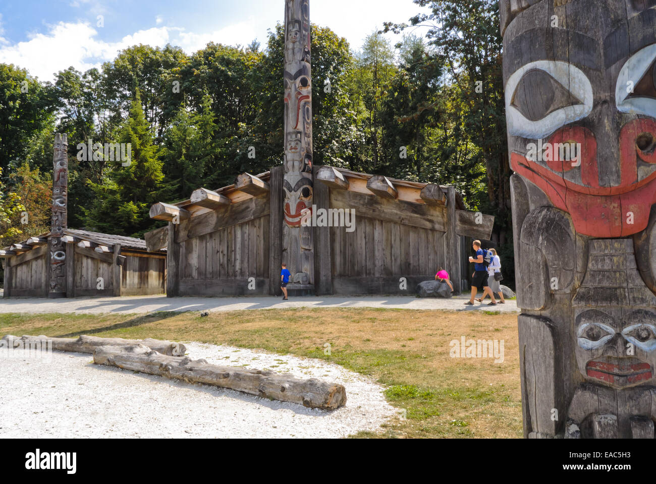 Museum of Anthropology grounds with totem poles and First Nations' house in background Stock Photo