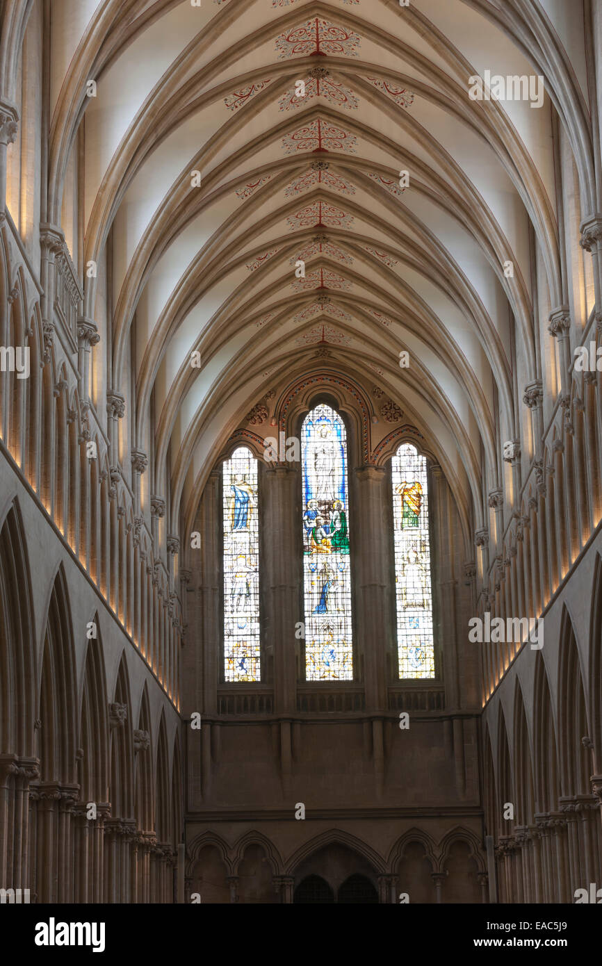 Stained glass windows and the vaulted ceiling of an aisle of Wells Cathedral, Somerset Stock Photo