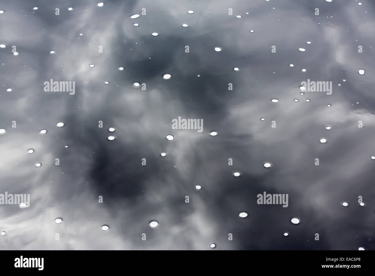 White bubbles on dark water surface Stock Photo