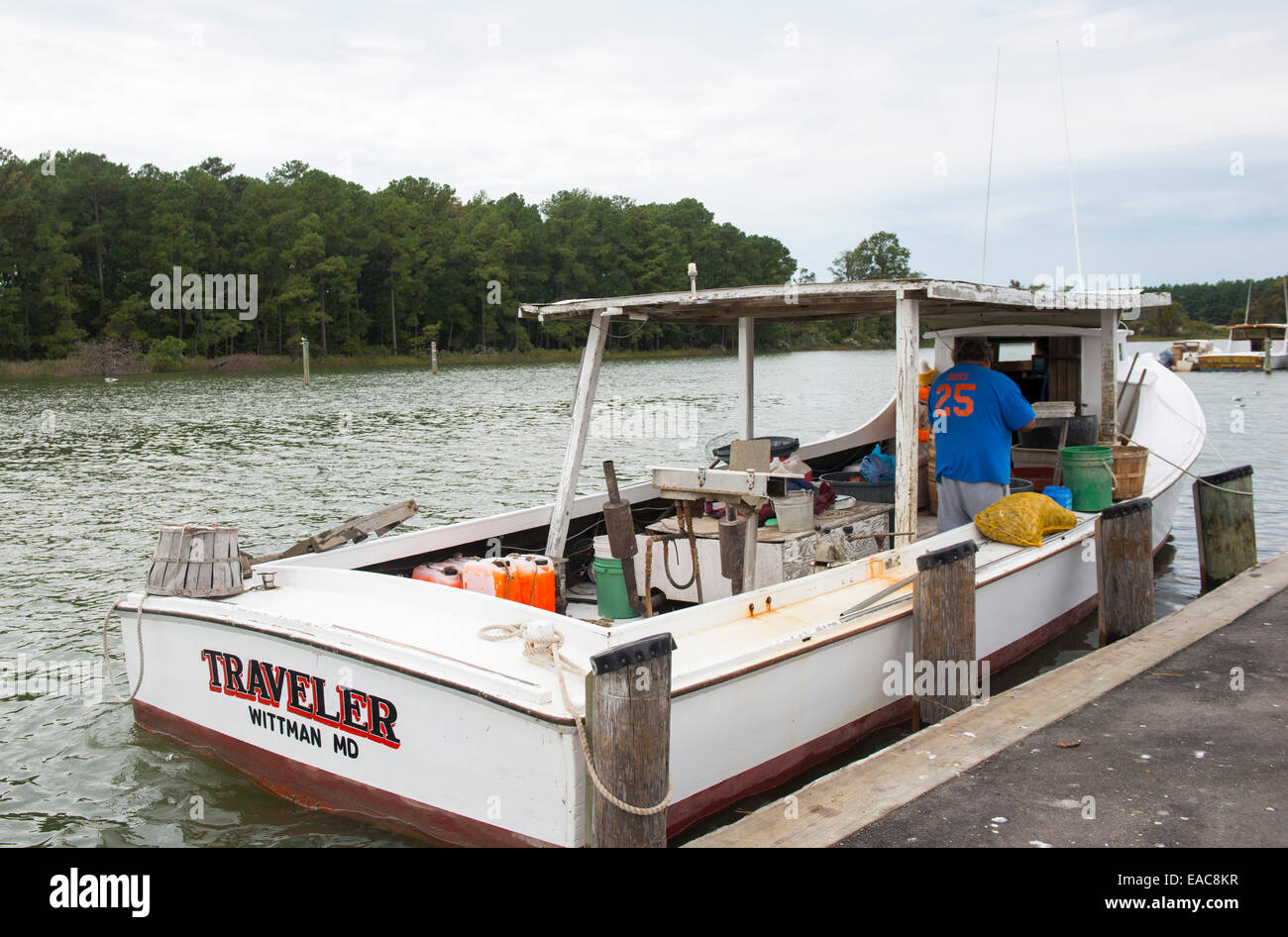 A man working on his fishing boat on Tilghman Island Maryland USA Stock Photo