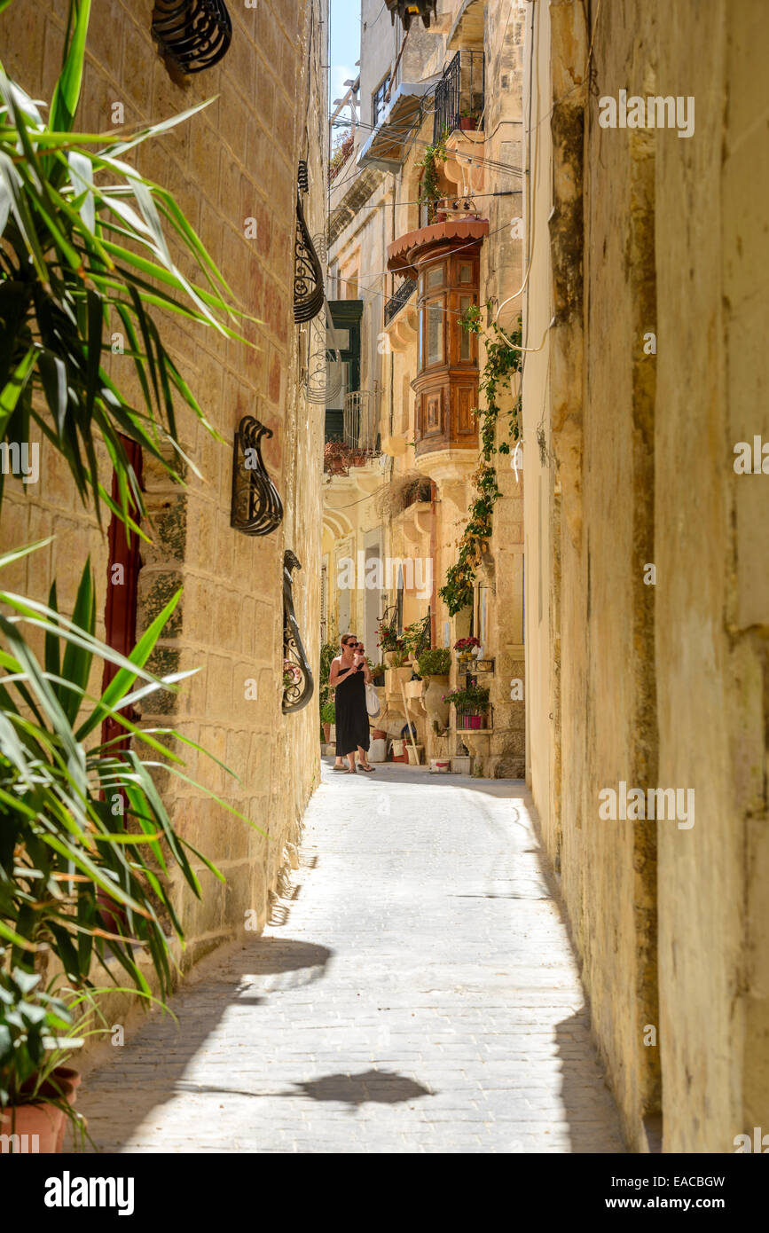 Rabat, Malta, narrow street with traditional sandstone buildings Stock Photo